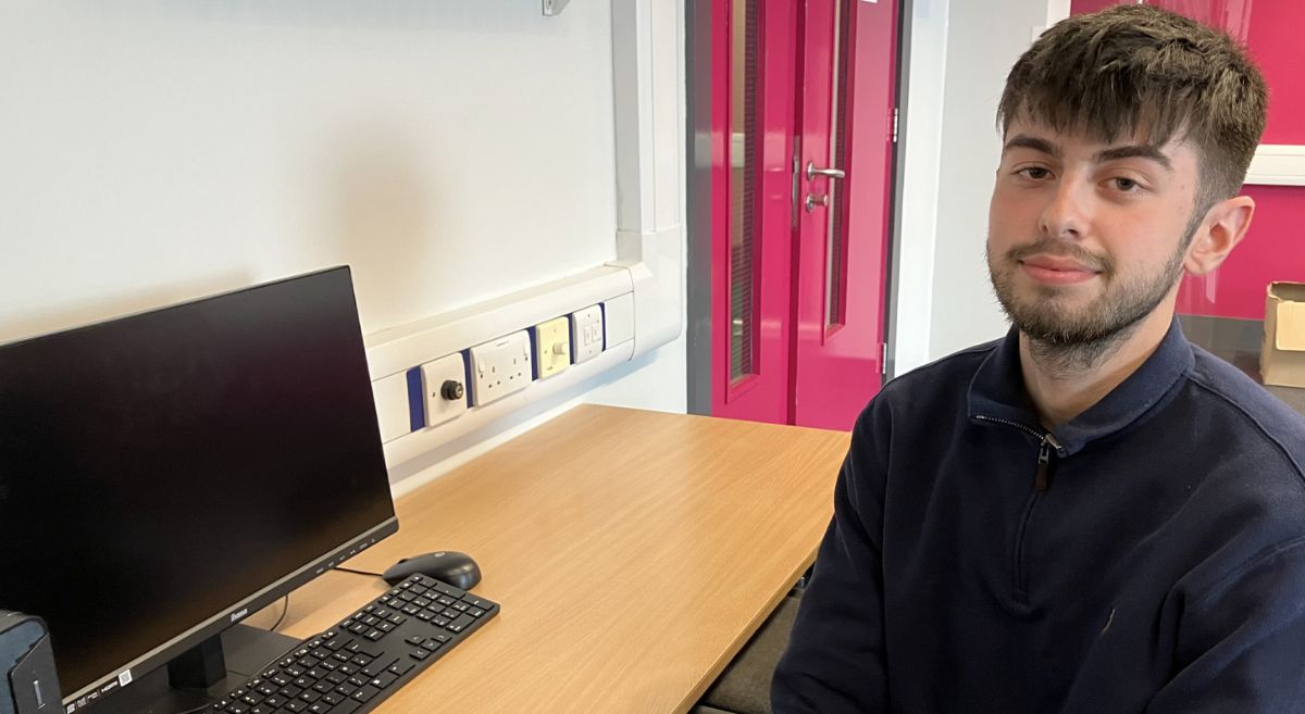 James Blakely sits at a computer desk in a SERC classroom where he studies once a week as part of his higher-level apprenticeship